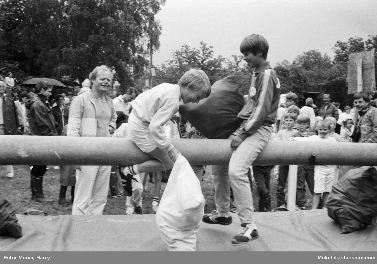 Midsommarfirande på Ekensås i Kållered, år 1984. "Pojkarna slogs så det stod härliga till på den såphala stången i sitt kuddkrig."

För mer information om bilden se under tilläggsinformation.