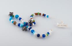 Komse, perlebånd til