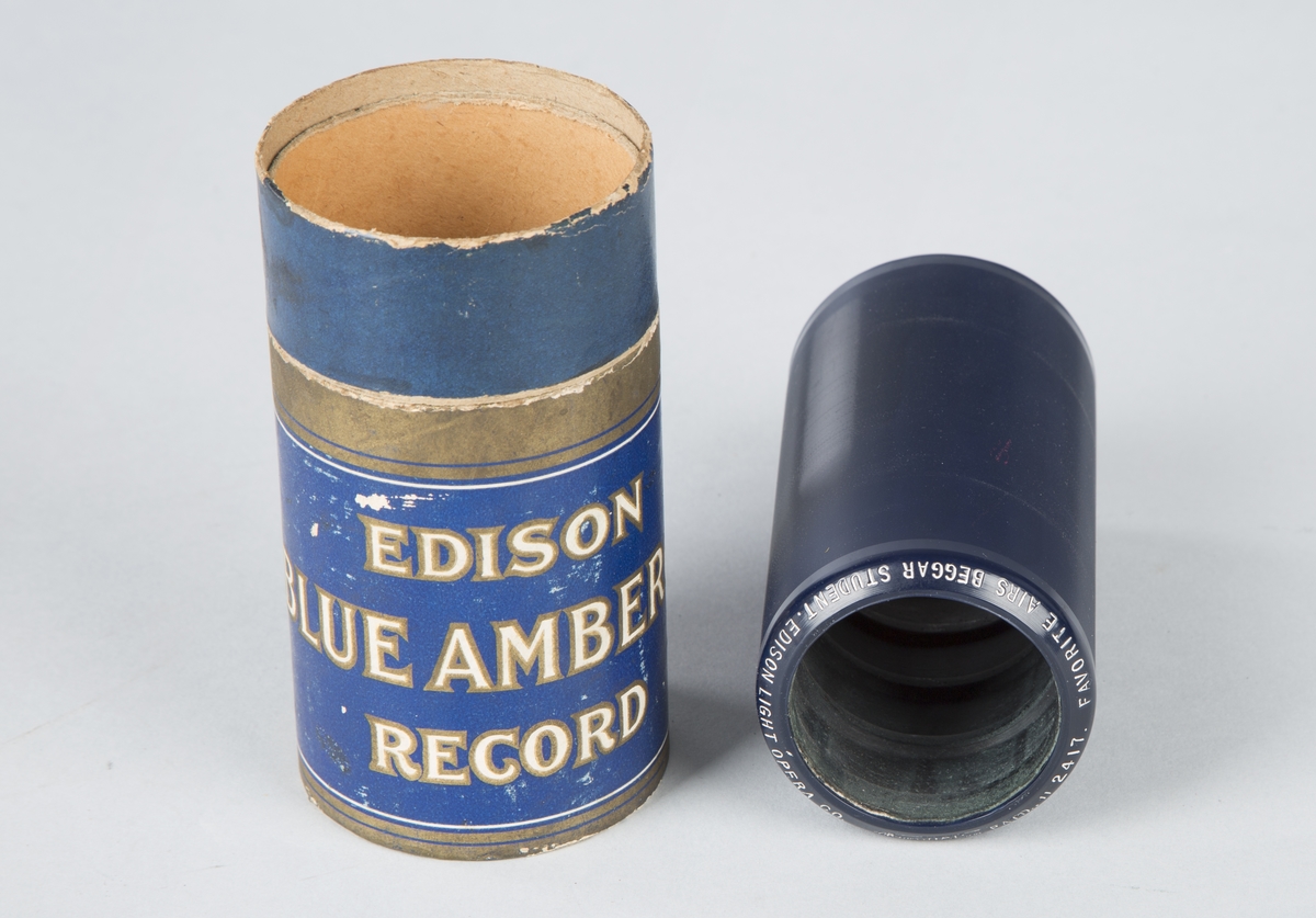 Voksrull for fonograf, med tilhørende blå- og gullmalt pappbeholder.