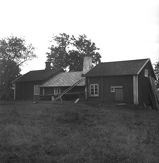 Foto av ett tredelat äldre bostadshus.
S.k. sydgötiskt hus (?) (AB).