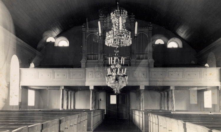 Foto i kyrkan mot orgelläktaren.
Den nya kyrkan är uppförd 1853 av byggmästare Petterson, Tångede efter ritningar av arkitekt Albert Törnqvist. Byggnadsstilen kan karaktäriseras som nyklassicistisk med vissa inslag av barock och gotik beträffande tornkrönet.