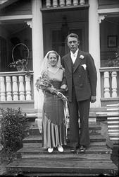 Brudepar på trapp foran hus