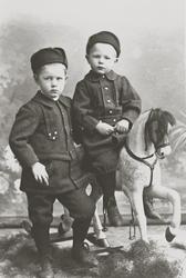 Portrett av to gutter på gyngehest. Bestillers navn er Onsta