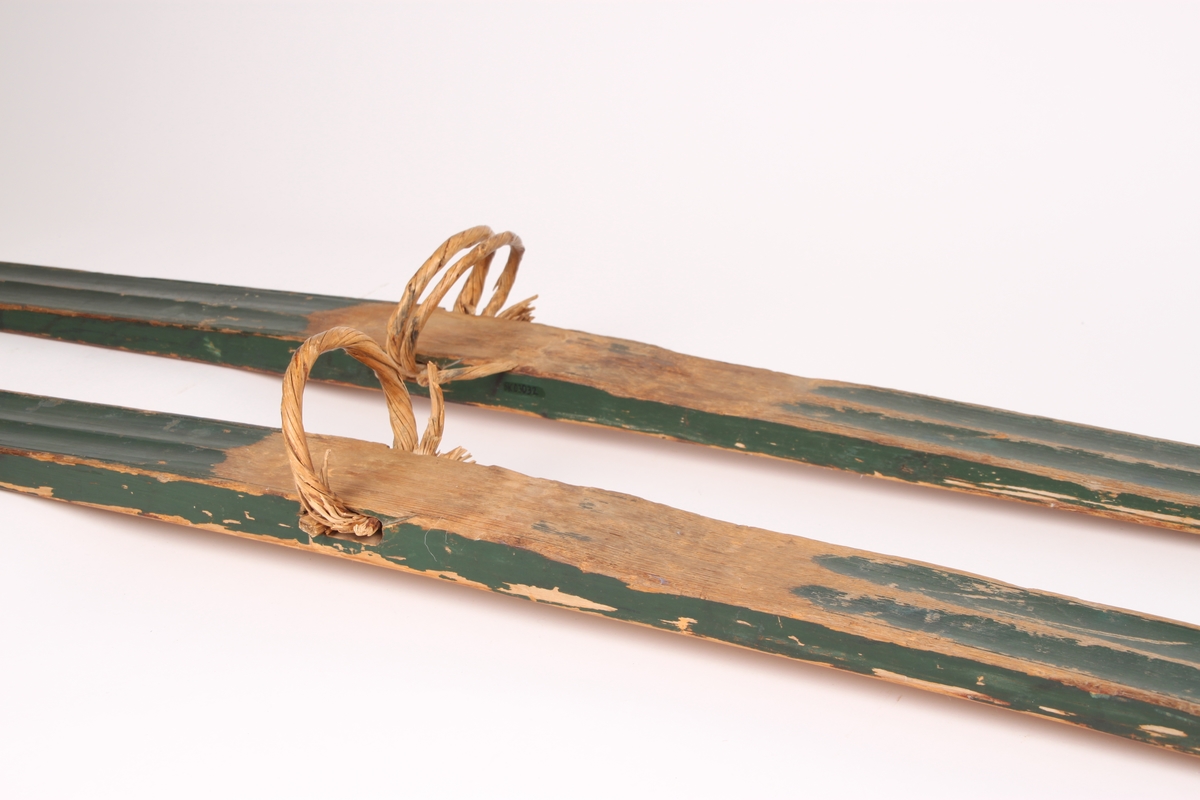 Et par treski i helved med lang og smal tupp, flat overside og fortykning under. Avsmalnende framski og jevnbred bakski og møneformet rygg langs hele skiens lengde. Dekoren er fra Krødsherad med fremre del av framskien malt i svart, og med rosett og navn med årstall i hvitt. Rosett også på skienes bakende. Skiene har tåstropp av vidje og har sannsynligvis hatt ilkebinding. Bindingshullene har innskjæring med skråsnitt på skienes sider. Skiene er rett avskåret bak. Ingen rand under.