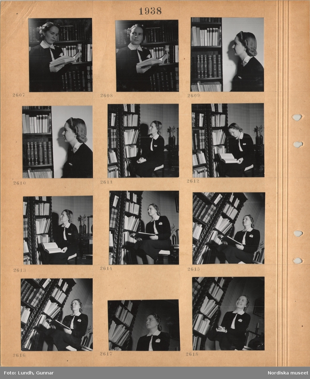 Motiv: En ung kvinna står framför en bokhylla med en bok i handen, kvinna sitter på en stol.
