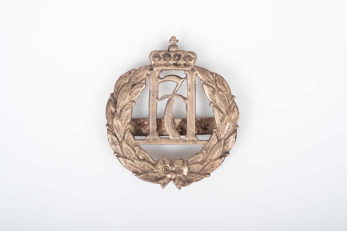 Symbolet H7 med en krone omringet av en laurbærkrans.