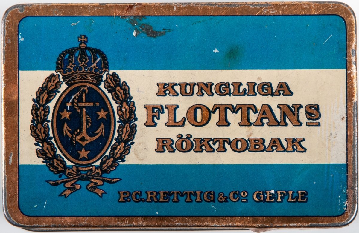 Plåtask i blått  med reklam för P.C Rettig & co Gefle och märket Kungliga flottans röktobak.
På sidan ristat namnet: Bengt Pousette Gävle.