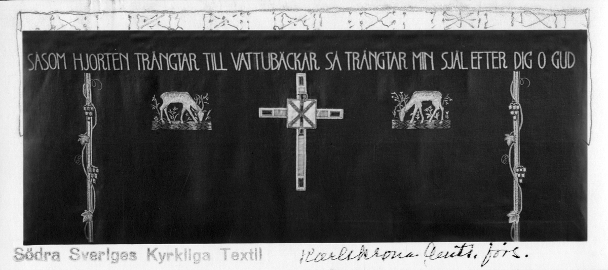 Foto (svart/vitt) av ett mörkt antependium broderat med hjortar m.m., text: "Såsom Hjorten Trängtar Till Vattubäckar Så Trängtar Min Själ Efter Dig O Gud". 

Inskrivet i huvudbok 1983.