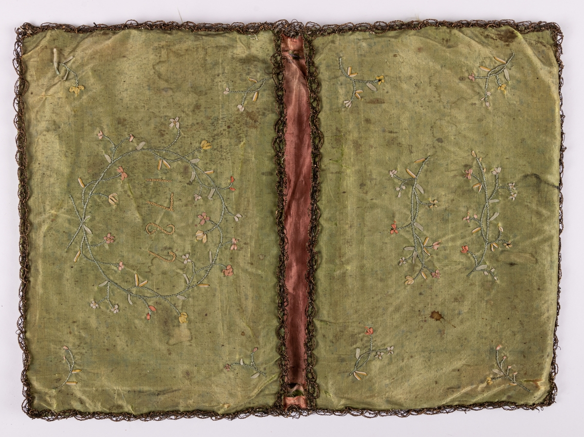 Plånbok i grönt siden, fodrad med rosa siden. Broderad med silke och smala band. Märkt 1782.