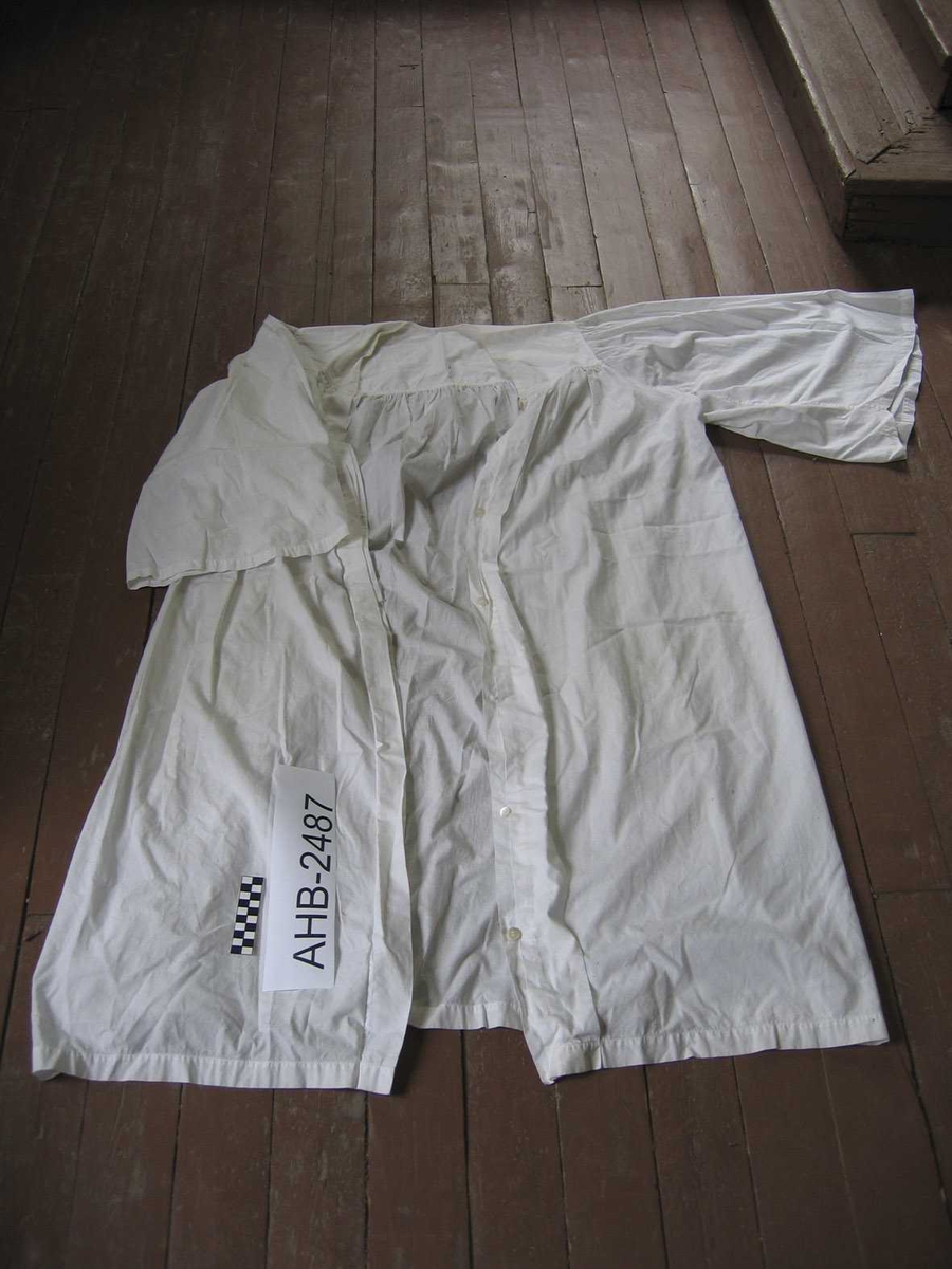 Hvit "frakk" i tynt bomullstoff beregnet på å bæres over svart prestekjole. Noe skitten (brukt)
