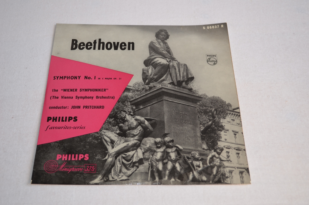 Grammofonplate med etui i papp. På pappetuiet er det bilete av ein statue av Beethoven. Biletet er i svart-kvit medan teksten står i ei rosa rubrikk.