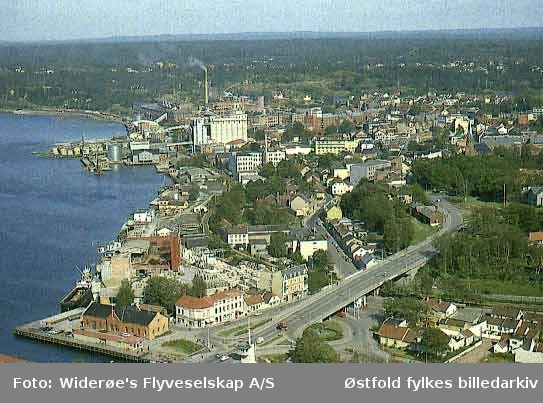 Oversiktsbilde og flyfoto over Sundbryggene og  Moss sentrum i 1964.
Bildet viser tydelig  omfanget av bygninger som måtte rives for å realisere Rådhusbrua tidlig på 1960-tallet.