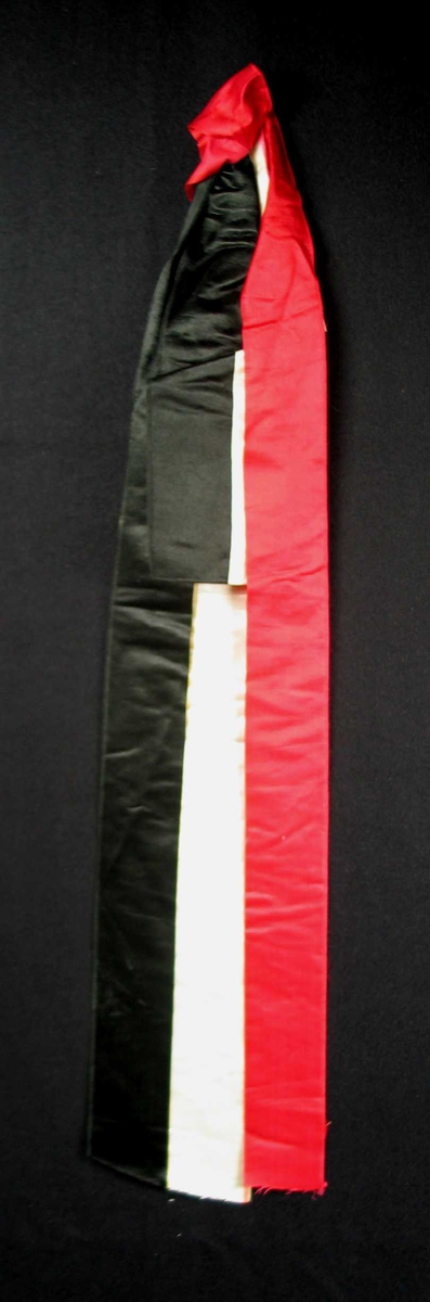 Begravelsessløyfe i hvit, rød og svart silke. Uten tekst.